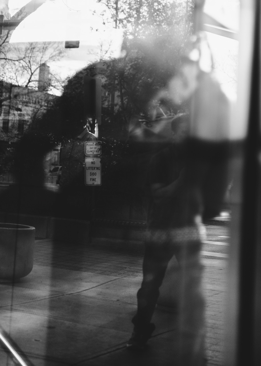 Maurice walking past a storefront after a show